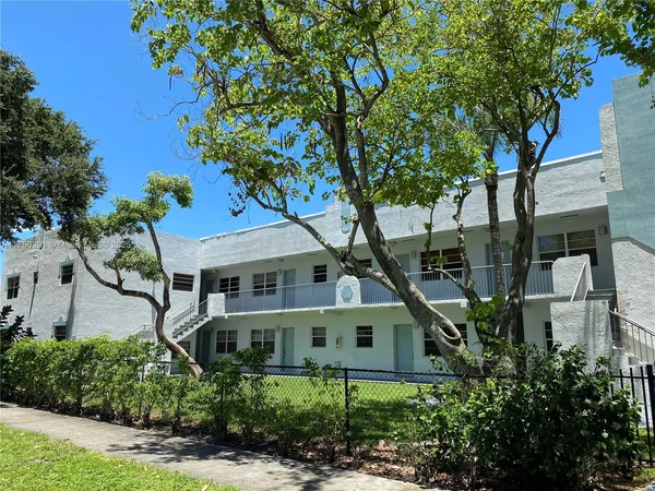 a house that has a tree in front of it