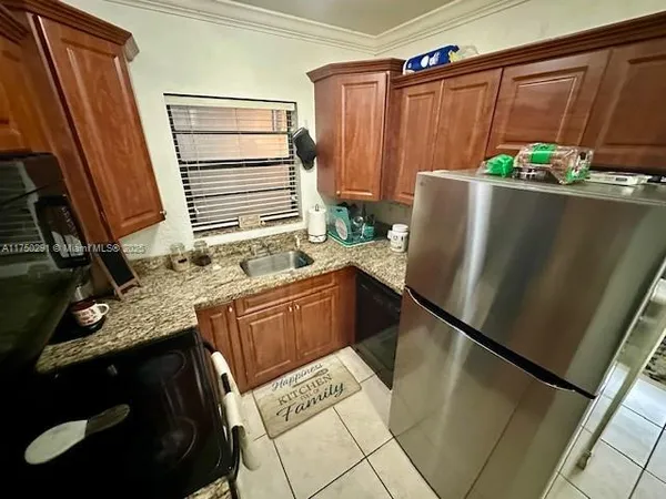 a kitchen with a refrigerator and sink