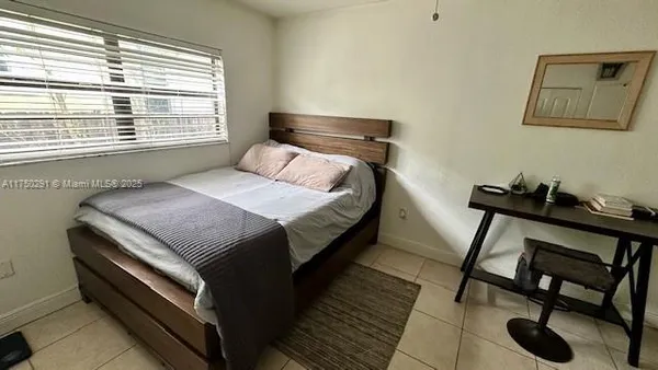 a bedroom with a bed and a desk