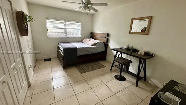 a spacious bedroom with a bed and a window