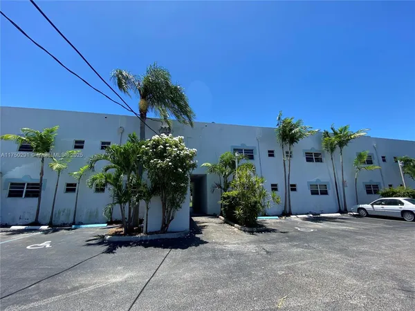 a palm tree sitting in front of a house