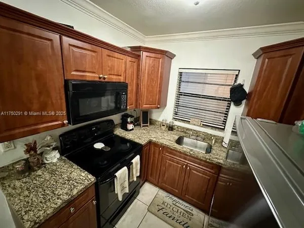 a kitchen with a stove a sink and a microwave