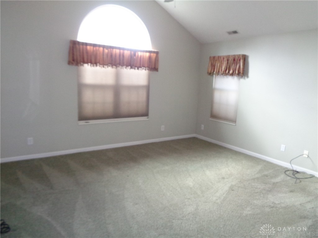 80 Villa Pointe Drive Springboro, OH 45066 - Photo 15 of 19 This spacious room features vaulted ceilings and ample natural light, creating an airy atmosphere.