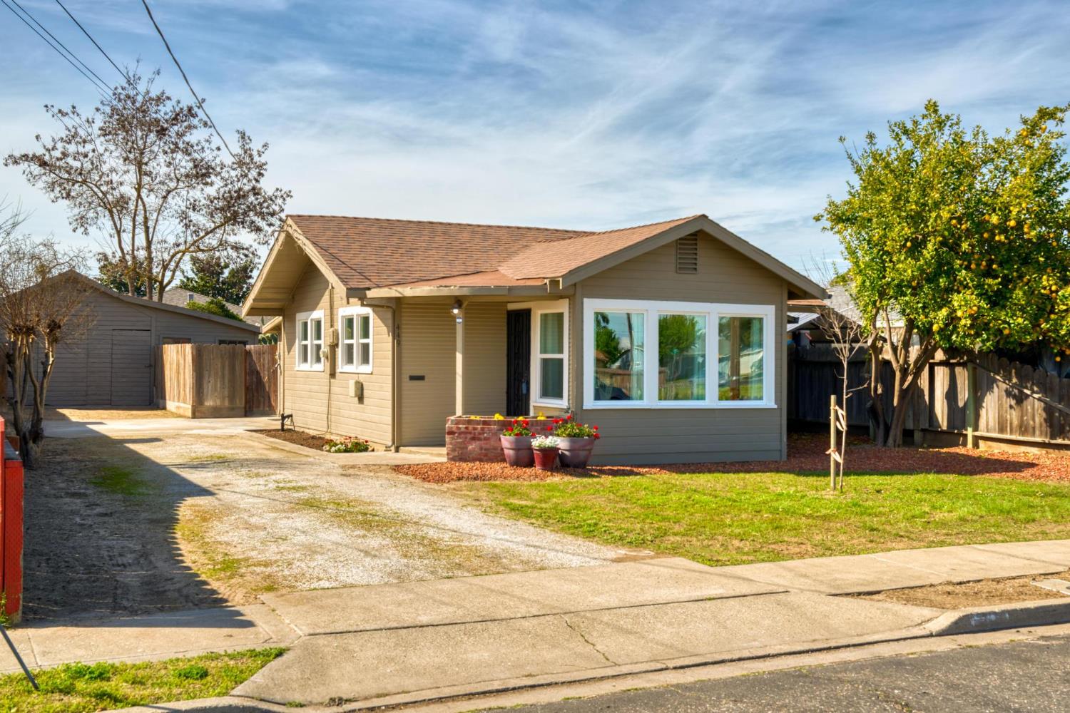 449 Poplar Avenue Manteca, CA 95336 - Photo 1 of 1 a front view of a house with a yard and garage