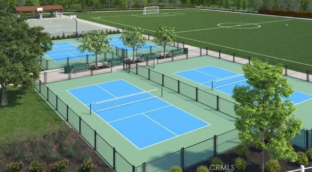 a view of a tennis court with chairs