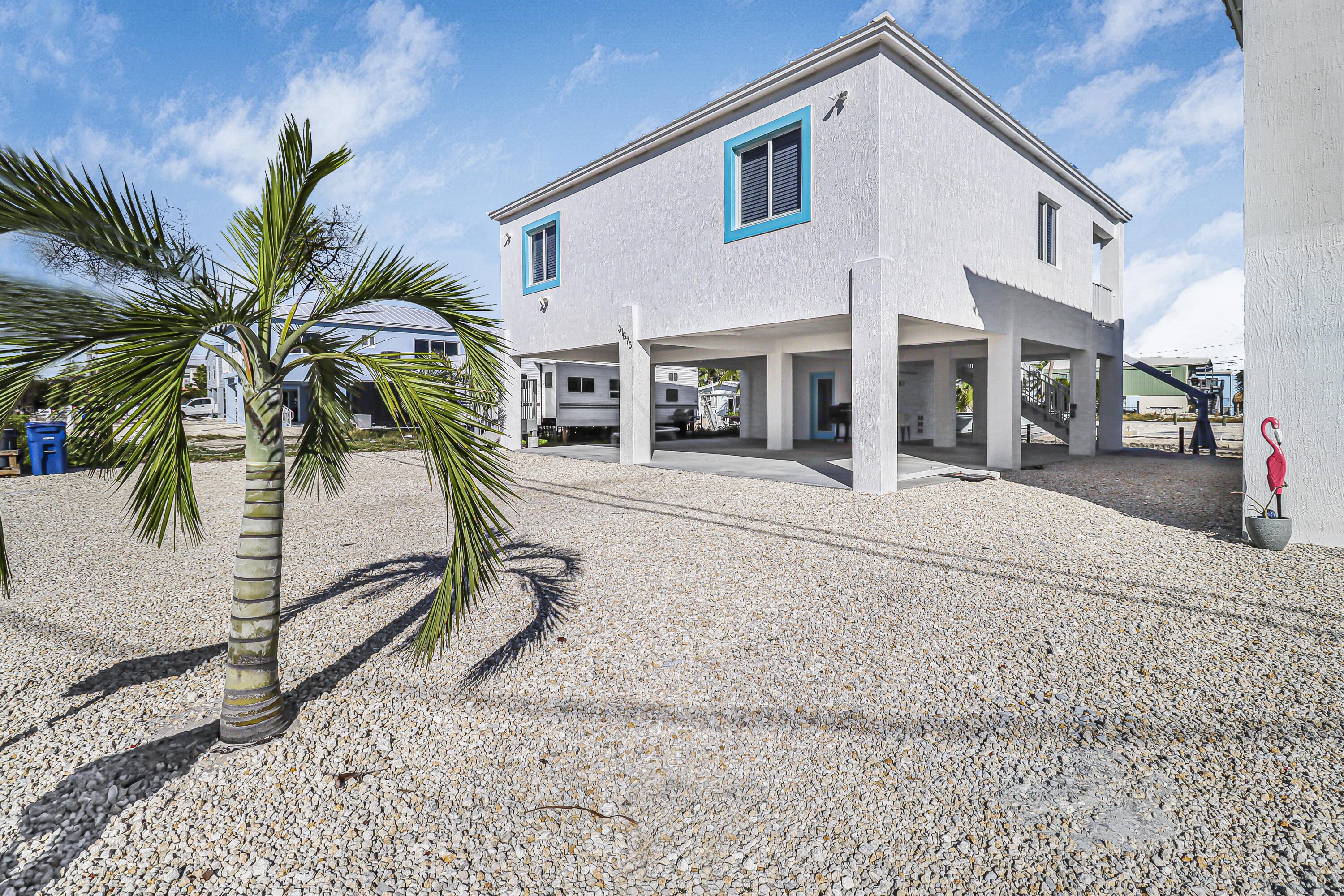31575 Ave D Big Pine Key, FL 33043 - Photo 3 of 35 a view of a white house with a patio