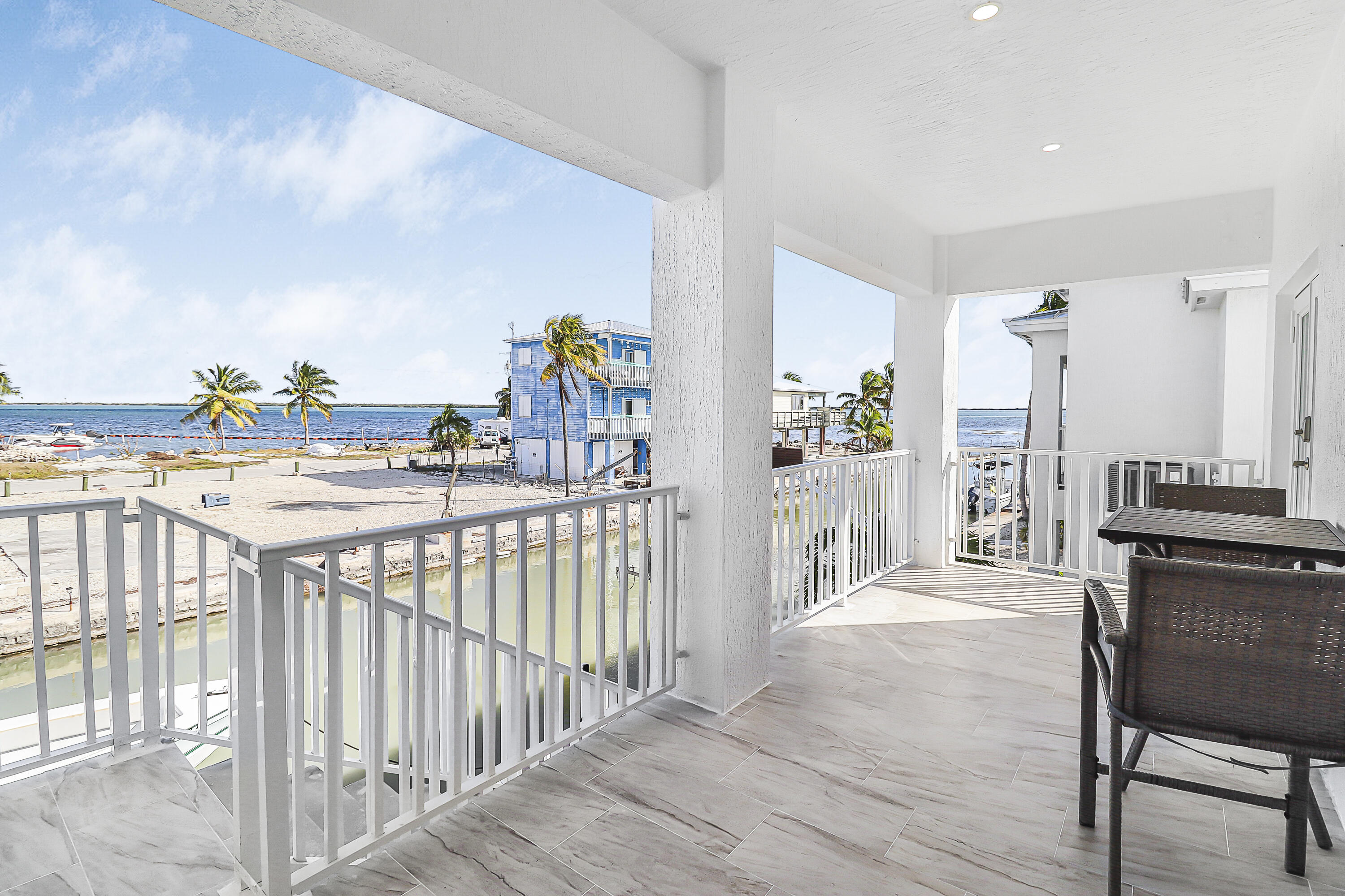 31575 Ave D Big Pine Key, FL 33043 - Photo 8 of 35 a bedroom with furniture and a wooden floor