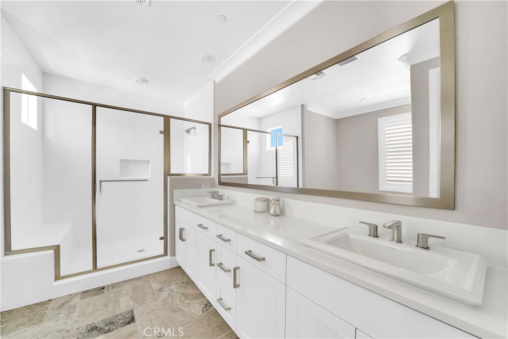 249 Chorus Irvine, CA 92618 - Photo 20 of 37 a bathroom with a double vanity sink and mirror