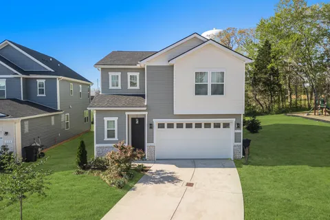 a front view of a house with a yard