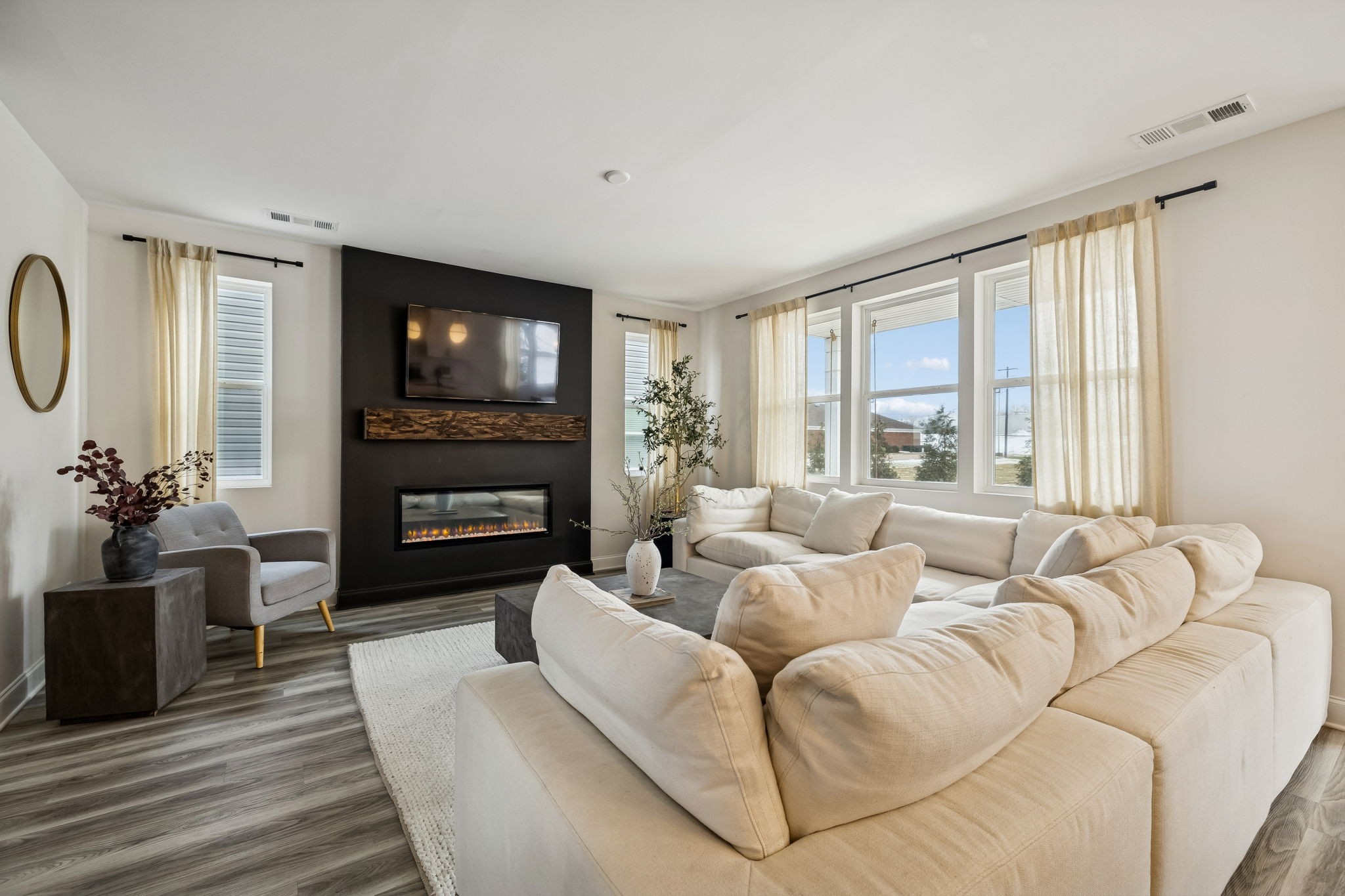 117 Timber Crest Trail White Bluff, TN 37187 - Photo 5 of 39 a living room with furniture a fireplace a flat screen tv and a large window