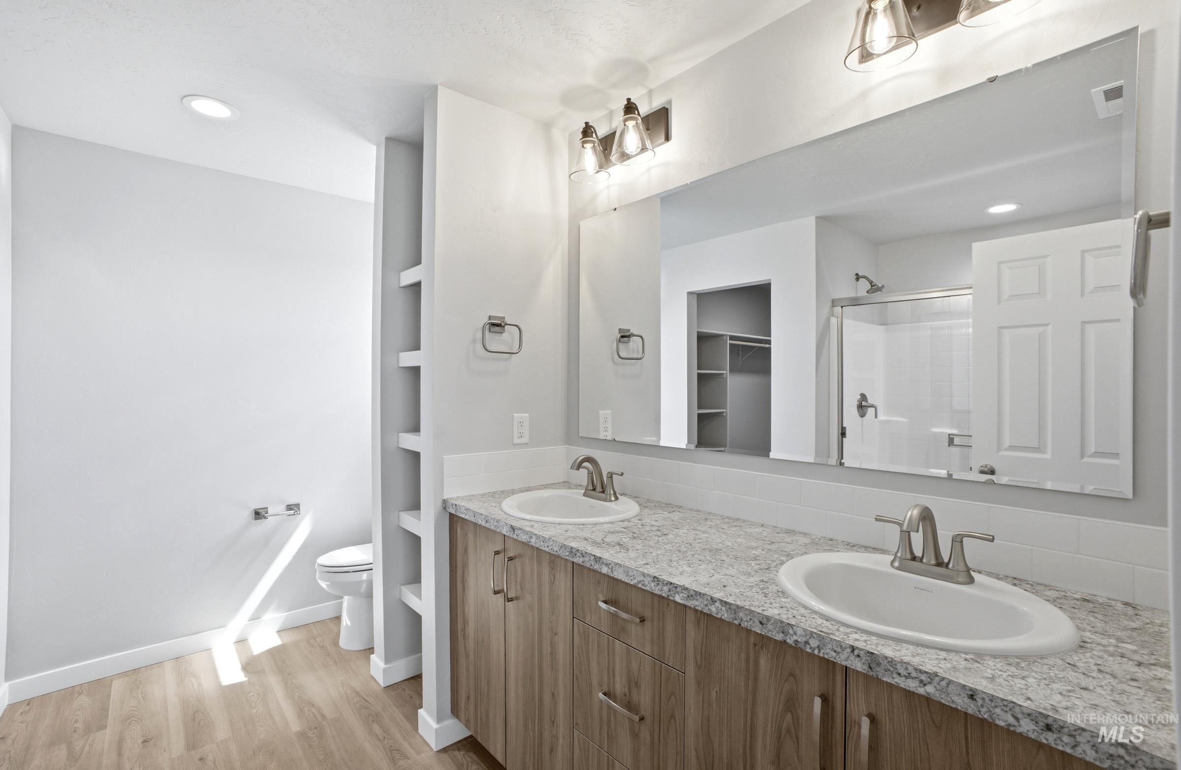 14106 Winding Street Caldwell, ID 83607 - Photo 17 of 18 Bathroom featuring a dual vanity with light-colored wood-finish cabinetry and a speckled countertop