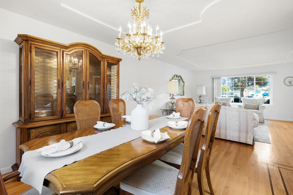 755 Cumberland Drive Gilroy, CA 95020 - Photo 11 of 52 a view of a dining room with furniture a chandelier and wooden floor