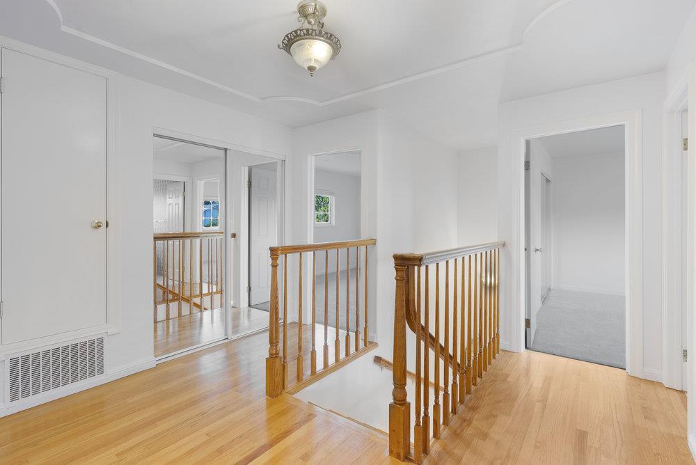 755 Cumberland Drive Gilroy, CA 95020 - Photo 33 of 52 a view of a hallway with wooden floor and a chandelier