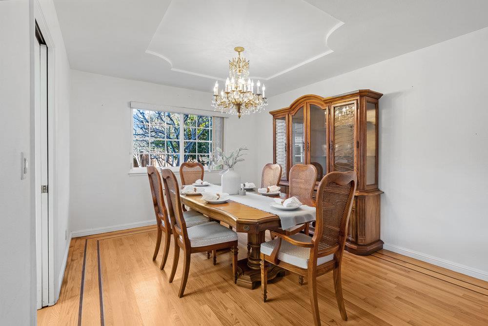 755 Cumberland Drive Gilroy, CA 95020 - Photo 10 of 52 a view of a dining room with furniture a chandelier and wooden floor