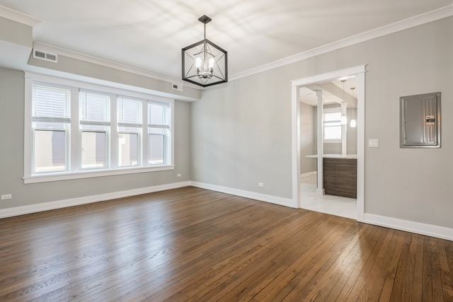 1535 West Estes Avenue, Unit 3 Chicago, IL 60626 - Photo 12 of 40 a view of an empty room with wooden floor and a window