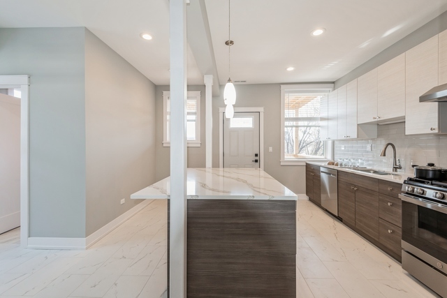 1535 West Estes Avenue, Unit 3 Chicago, IL 60626 - Photo 15 of 40 a kitchen with stainless steel appliances granite countertop a sink a stove and a refrigerator