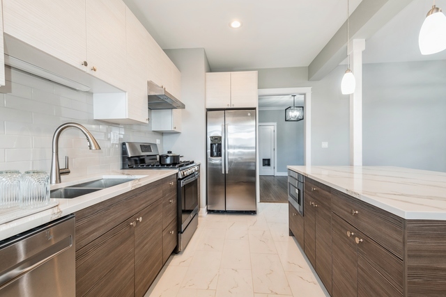 1535 West Estes Avenue, Unit 3 Chicago, IL 60626 - Photo 16 of 40 a kitchen with granite countertop a sink stainless steel appliances and cabinets
