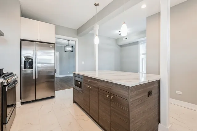 a kitchen with a refrigerator sink and a refrigerator