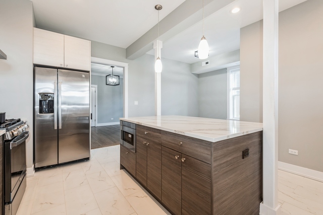 1535 West Estes Avenue, Unit 3 Chicago, IL 60626 - Photo 17 of 40 a kitchen with a refrigerator sink and a refrigerator