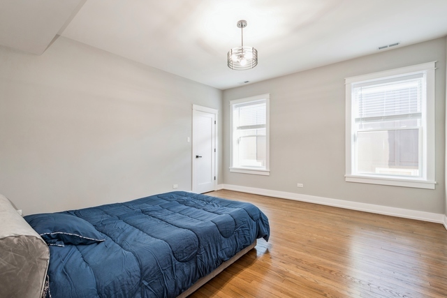 1535 West Estes Avenue, Unit 3 Chicago, IL 60626 - Photo 18 of 40 a bedroom with a bed and a window