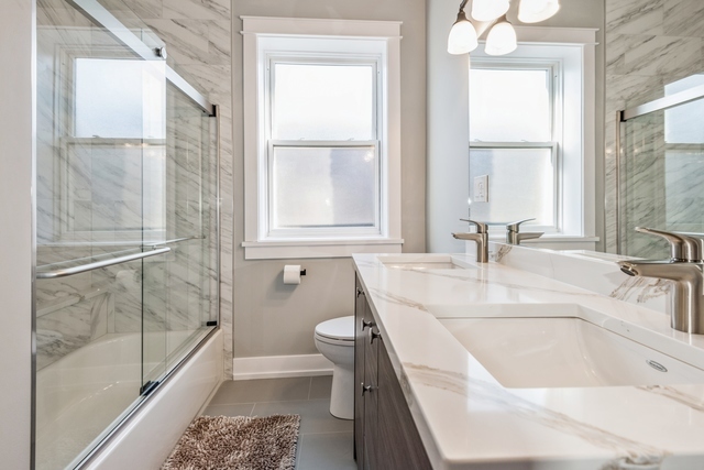 1535 West Estes Avenue, Unit 3 Chicago, IL 60626 - Photo 23 of 40 a bathroom with a tub sink and mirror
