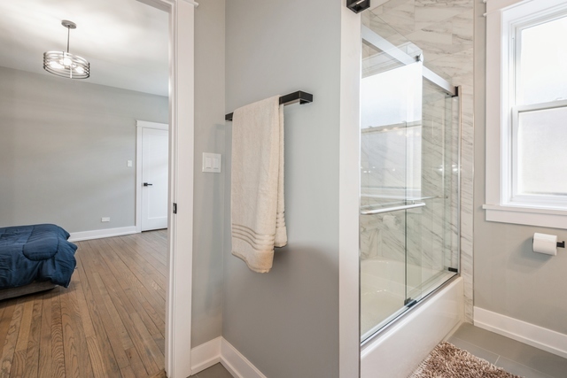 1535 West Estes Avenue, Unit 3 Chicago, IL 60626 - Photo 24 of 40 a bathroom with a tub and shower