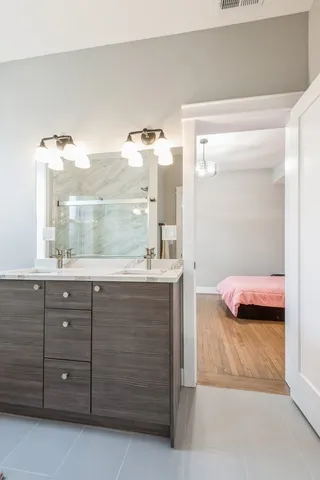 a bathroom with a granite countertop sink and a mirror