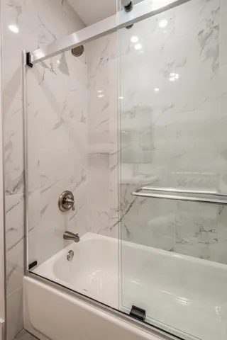a bathroom with a bathtub and a shower