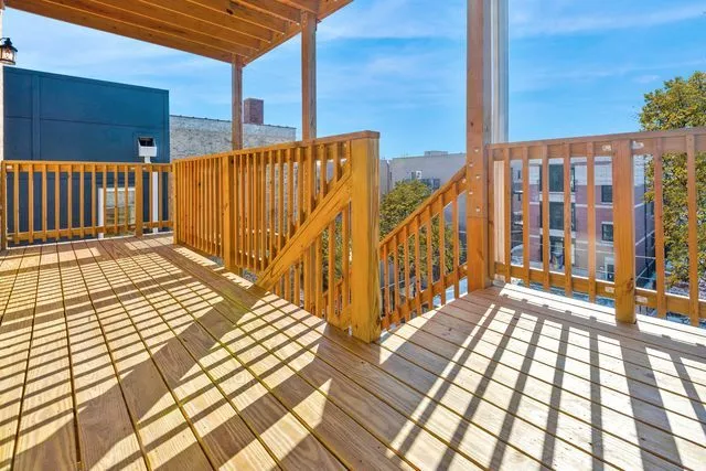 a view of a balcony with wooden floor