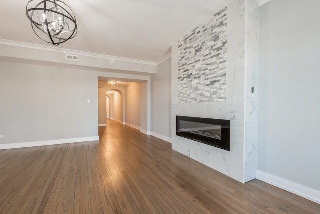 1535 West Estes Avenue, Unit 3 Chicago, IL 60626 - Photo 6 of 40 a view of an empty room with wooden floor and a window