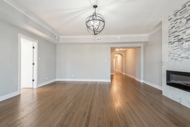 a view of a room with wooden floor and fireplace