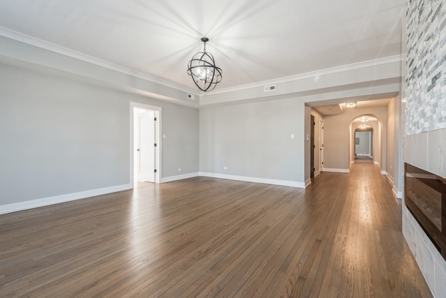1535 West Estes Avenue, Unit 3 Chicago, IL 60626 - Photo 8 of 40 a view of a room with wooden floor and chandelier