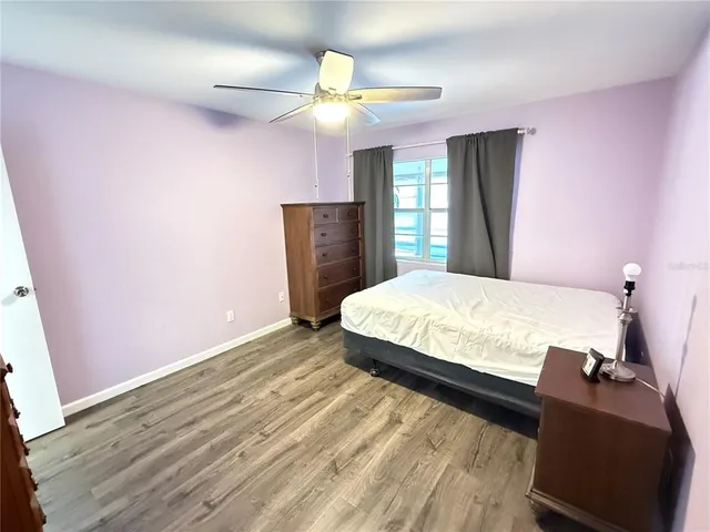 a bedroom with a bed dresser and a window