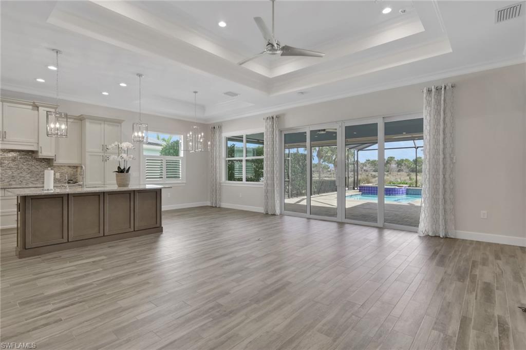6482 Warwick Avenue Naples, FL 34113 - Photo 14 of 50 an empty room with wooden floor and balcony