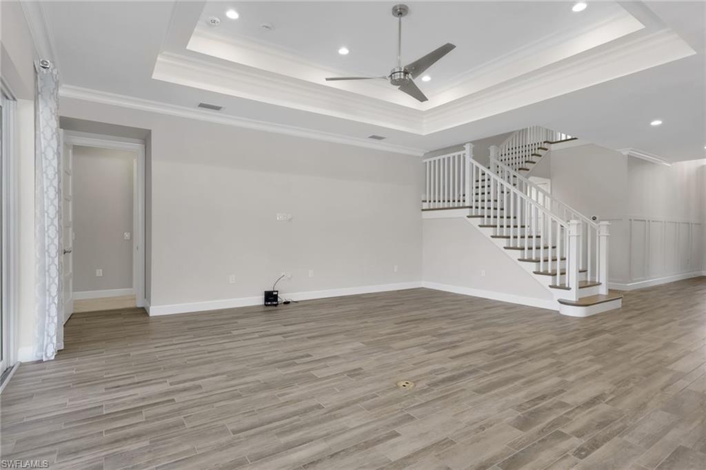6482 Warwick Avenue Naples, FL 34113 - Photo 16 of 50 a view of an empty room with wooden floor