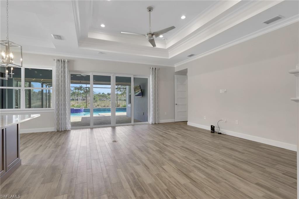 6482 Warwick Avenue Naples, FL 34113 - Photo 17 of 50 a view of an empty room with wooden floor and a window