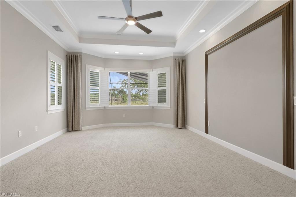 6482 Warwick Avenue Naples, FL 34113 - Photo 19 of 50 en empty room with windows and ceiling fan