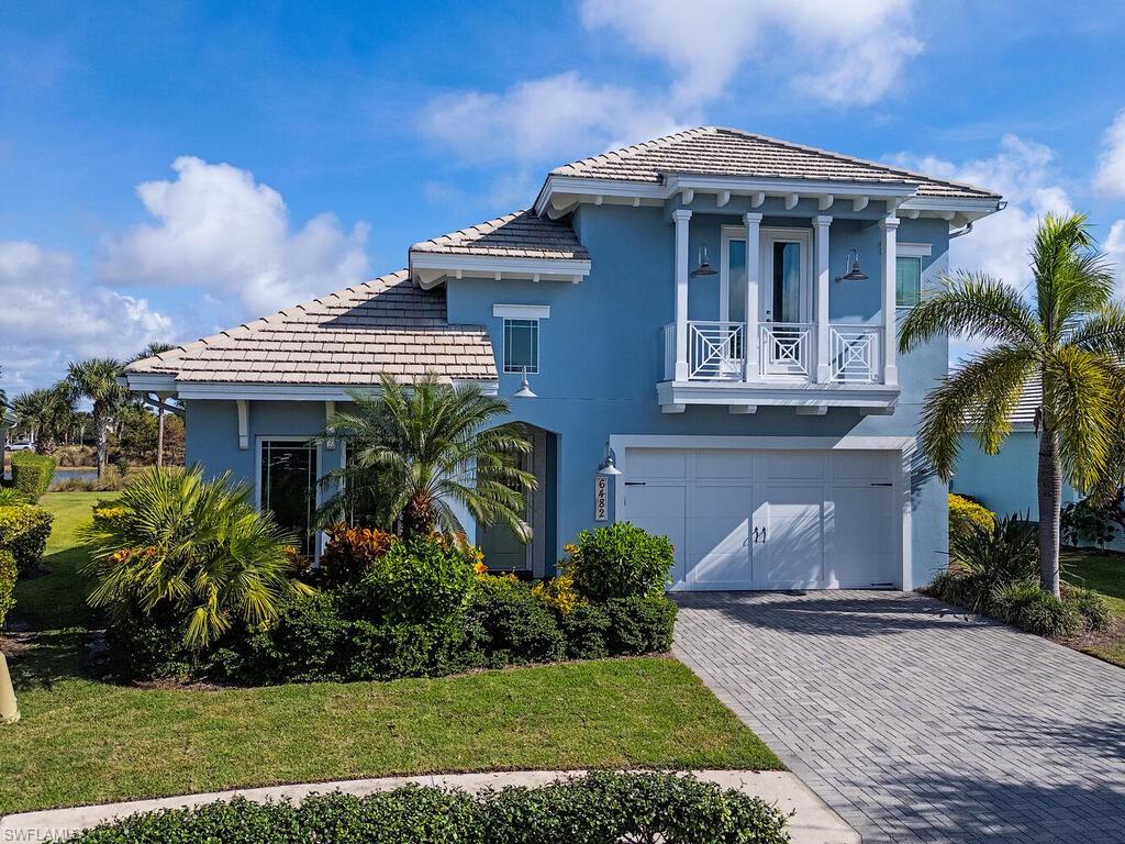6482 Warwick Avenue Naples, FL 34113 - Photo 2 of 50 a front view of a house with a yard
