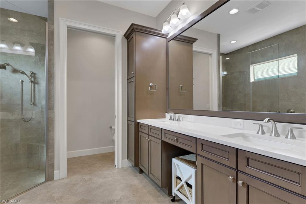 6482 Warwick Avenue Naples, FL 34113 - Photo 22 of 50 a bathroom with a granite countertop sink mirror and double