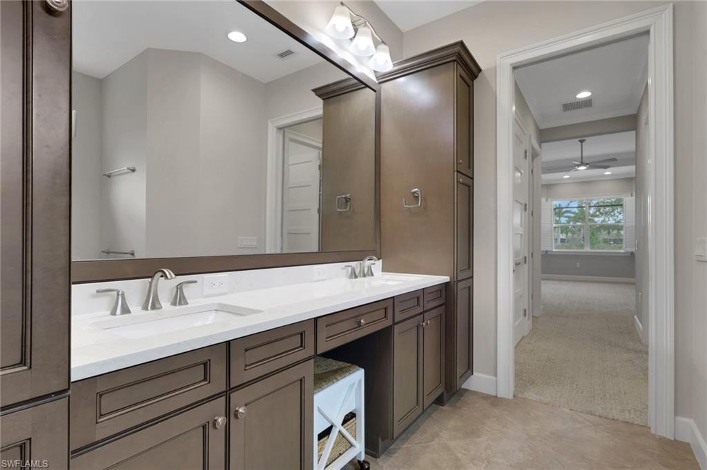 6482 Warwick Avenue Naples, FL 34113 - Photo 23 of 50 a bathroom with a sink and a mirror