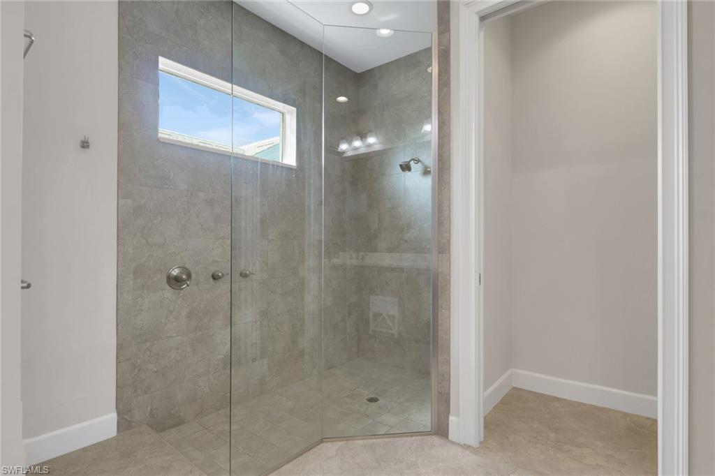 6482 Warwick Avenue Naples, FL 34113 - Photo 24 of 50 a bathroom with a glass shower door
