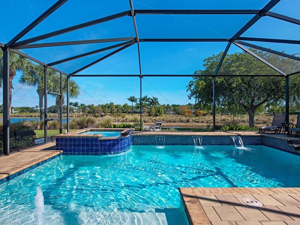 6482 Warwick Avenue Naples, FL 34113 - Photo 27 of 50 a view of a tub and chairs under an umbrella