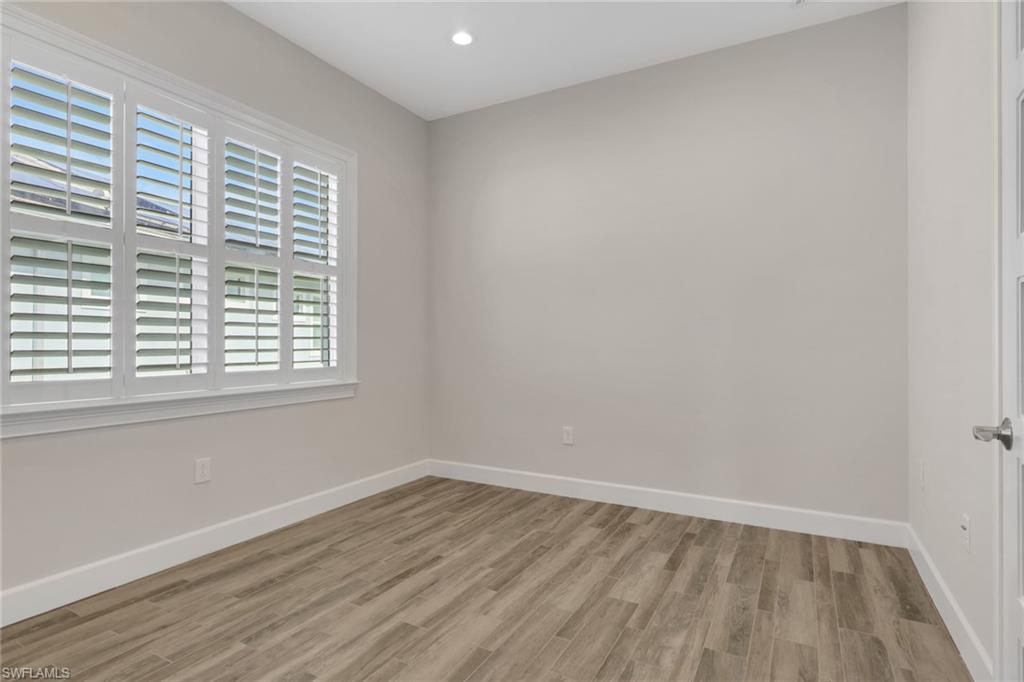 6482 Warwick Avenue Naples, FL 34113 - Photo 33 of 50 wooden floor in an empty room with a window