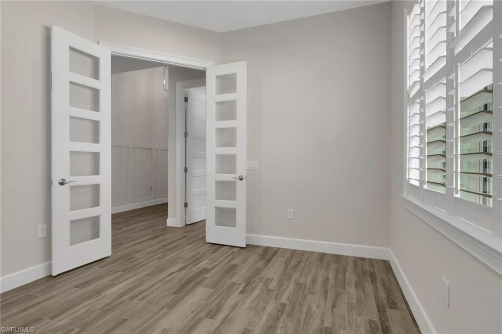 6482 Warwick Avenue Naples, FL 34113 - Photo 34 of 50 wooden floor in an empty room with a window
