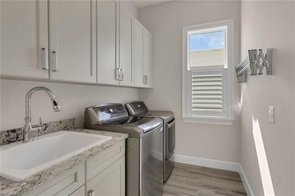 6482 Warwick Avenue Naples, FL 34113 - Photo 39 of 50 a utility room with sink dryer and washer
