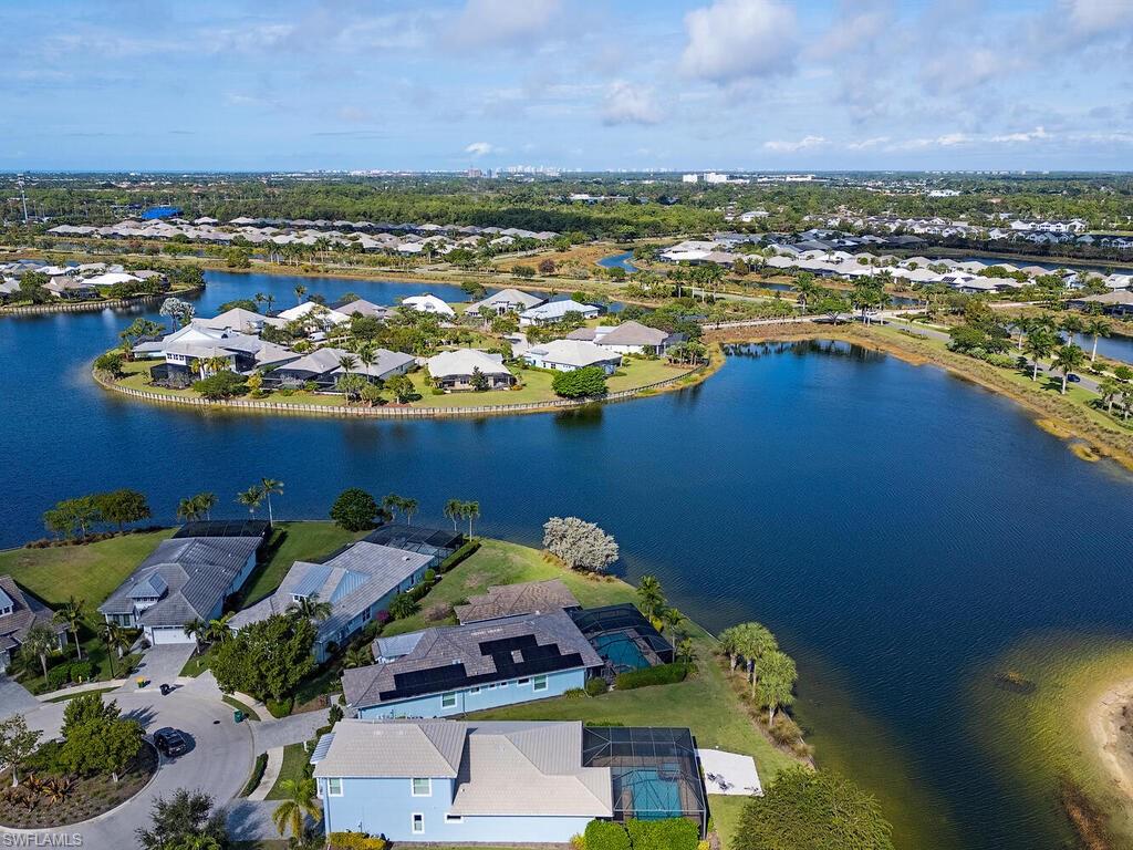6482 Warwick Avenue Naples, FL 34113 - Photo 40 of 50 a view of a lake with a table and chairs
