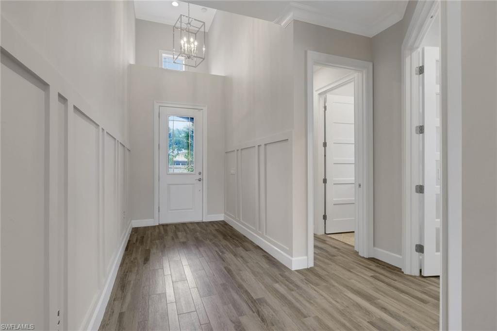 6482 Warwick Avenue Naples, FL 34113 - Photo 6 of 50 wooden floor in an empty room with a window