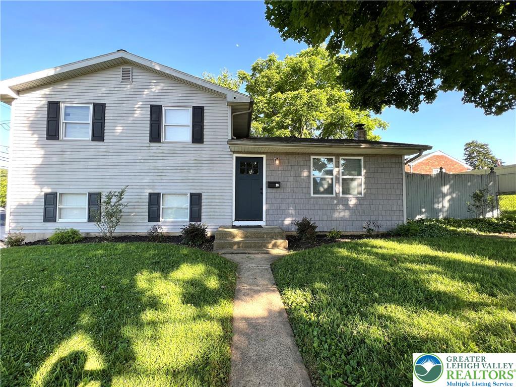 a front view of house with yard and green space