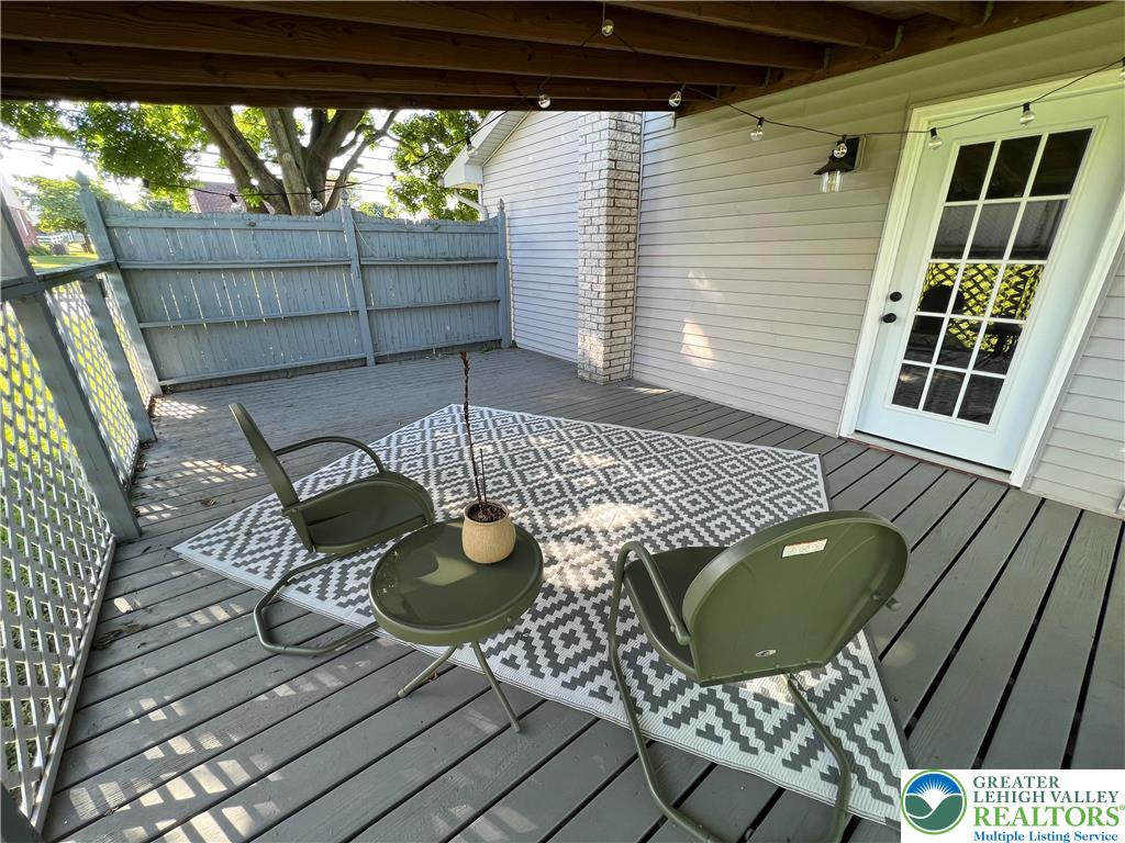28 Harrison Street Emmaus, PA 18049 - Photo 14 of 15 a view of a balcony with dining table and chairs with wooden floor