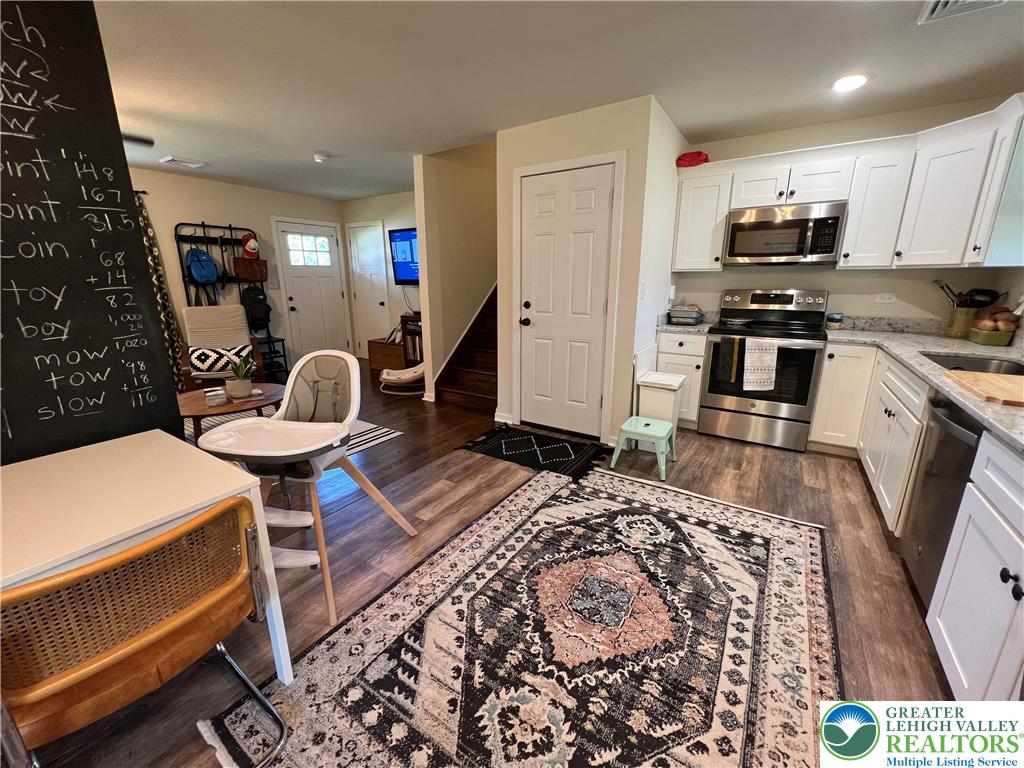 28 Harrison Street Emmaus, PA 18049 - Photo 6 of 15 a kitchen with a sink a stove a microwave a dining table and chairs